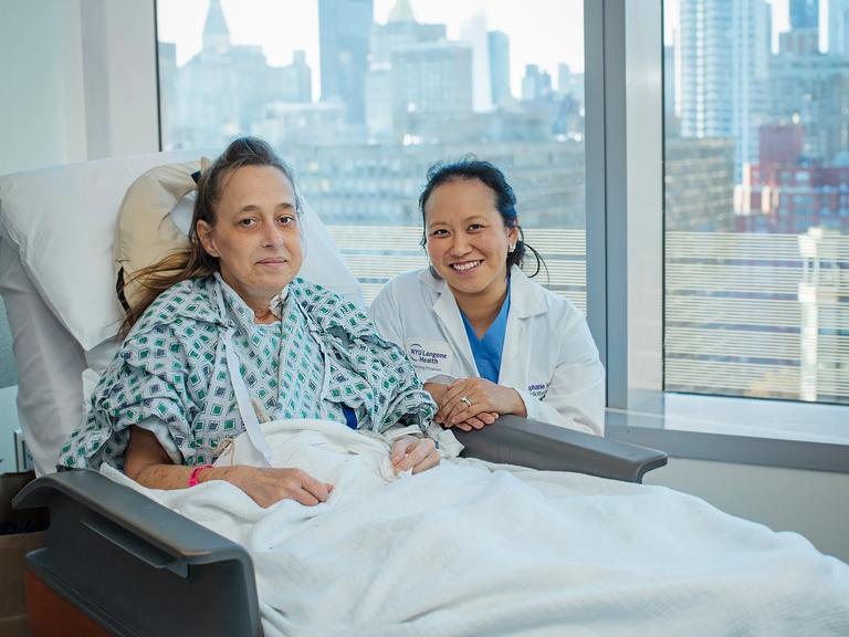 Cheryl Mehrkar, left, sits in a patient room at the hospital with Stephanie H. Chang, MD, right.