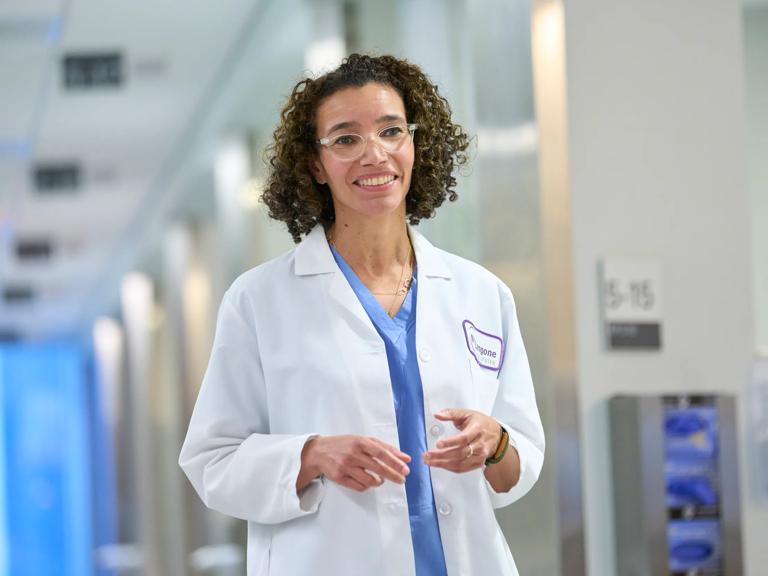 Leslie Boyd, MD, walks down a hallway.