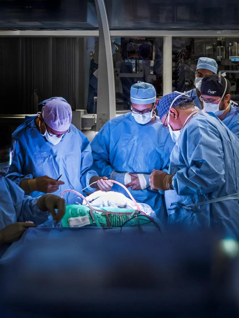John Golfinos, MD, J. Thomas Roland Jr., MD, and a resident perform surgery in an operating room at Tisch Hospital.