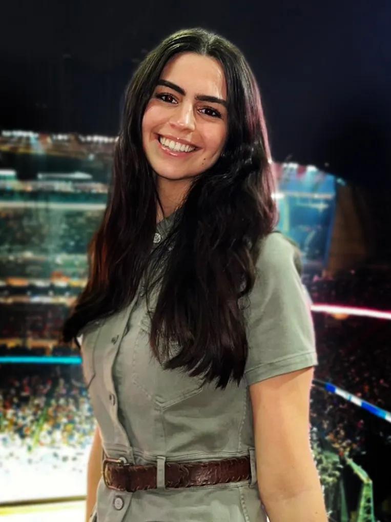 Sara Chemel, a student at NYU Grossman School of Medicine, smiles while wearing an olive green button down shirt.