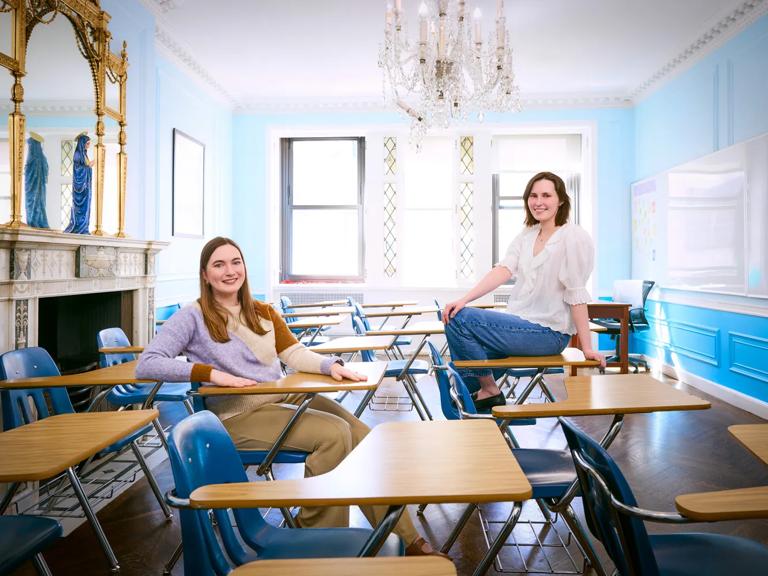 Lydia Fernandez, left, and Paula Schneider, right, sit in an old classroom.