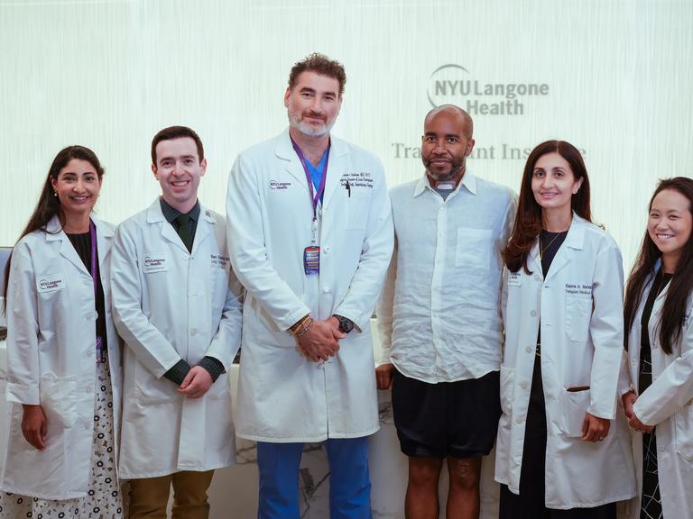 Bertrand Nelson, third from right, stands with members of his NYU Langone Transplant Institute care team.