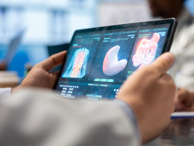 Doctor looking at CT scan data on a tablet.
