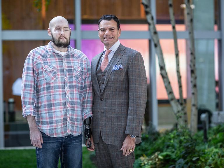 Aaron James and Eduardo D. Rodriguez standing next to each other in a courtyard.