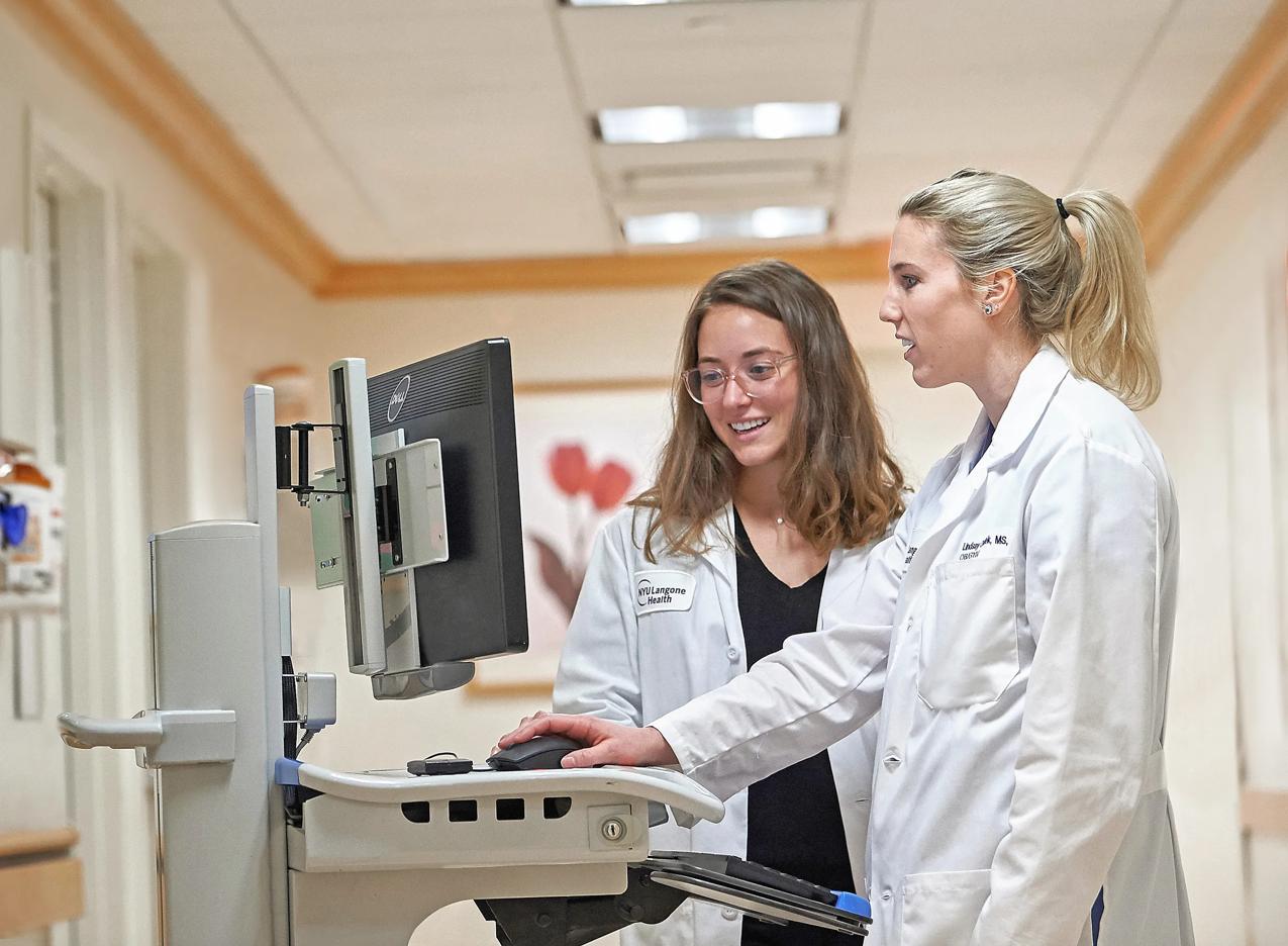OB-GYN doctors at Joan H. Tisch Center for Women’s Health look at patient records in a computer.