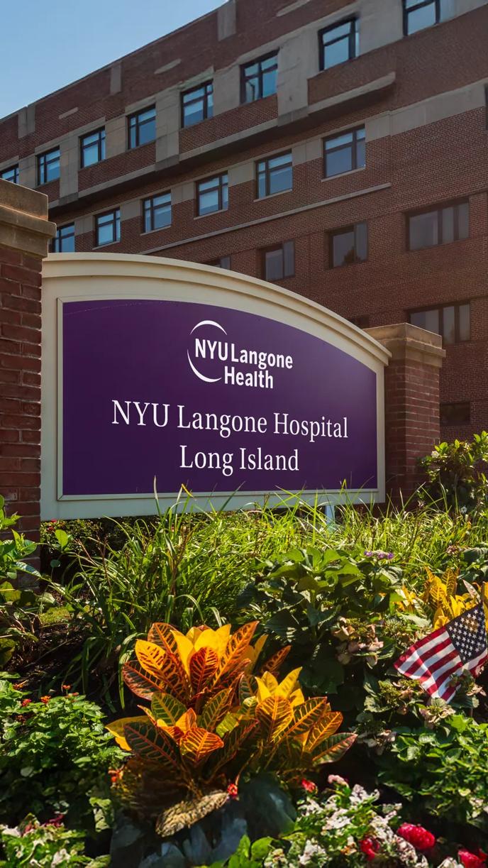 A sign reads "NYU Langone Hospital Long Island" on the hospital grounds.