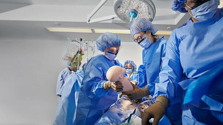Medical students learn how to deliver a baby in NYU Grossman School of Medicine's simulation center.