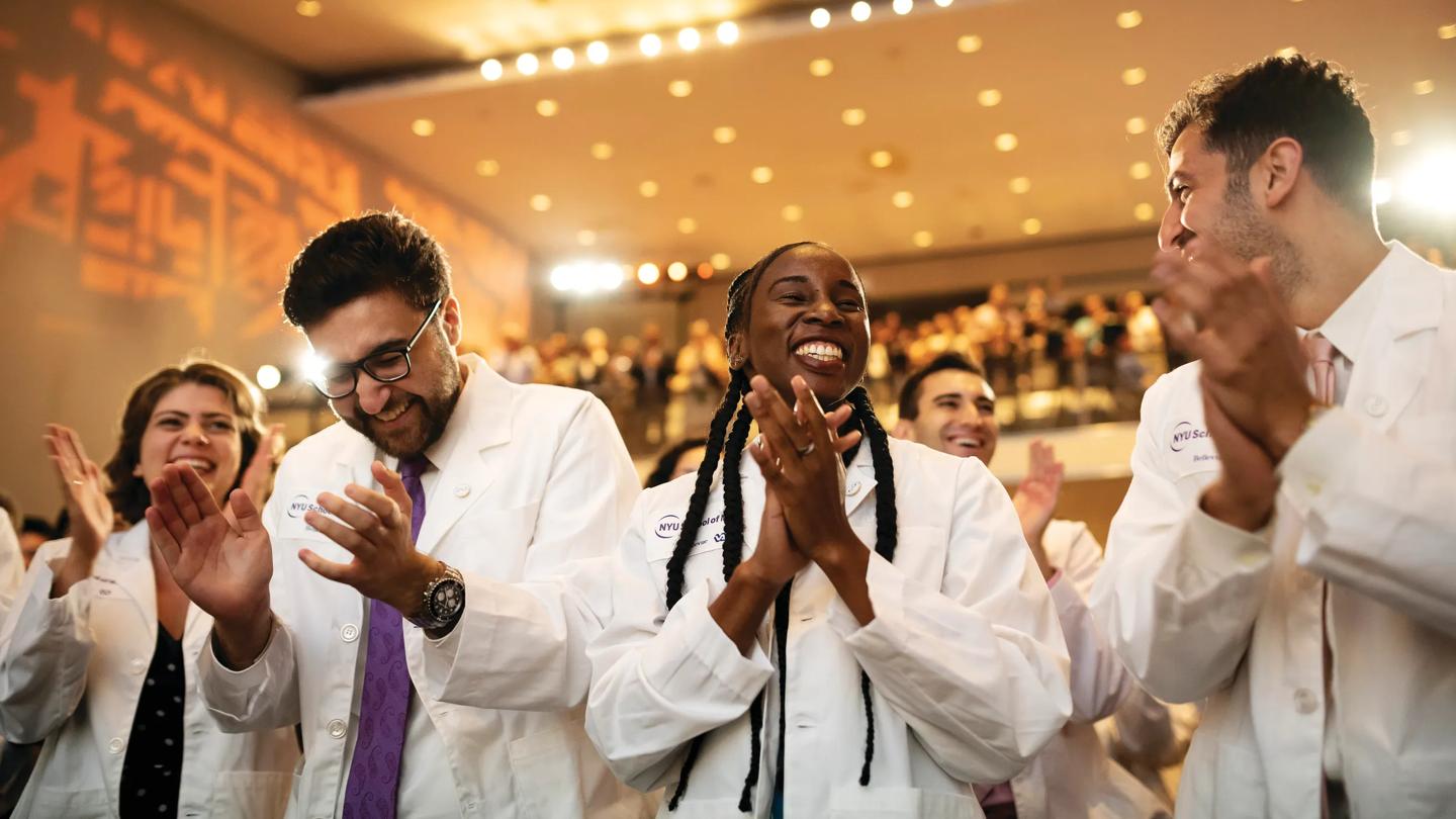 Student recieve their first white jackets during the White Coat Ceremony at NYU Grossman School of Medicine.