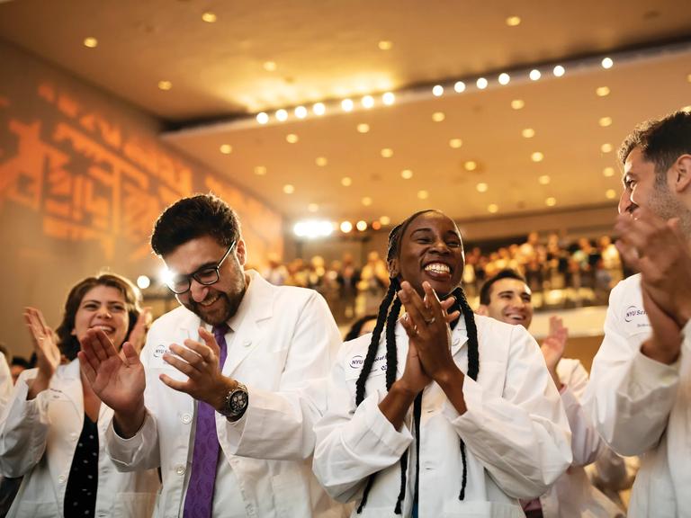 Student recieve their first white jackets during the White Coat Ceremony at NYU Grossman School of Medicine.