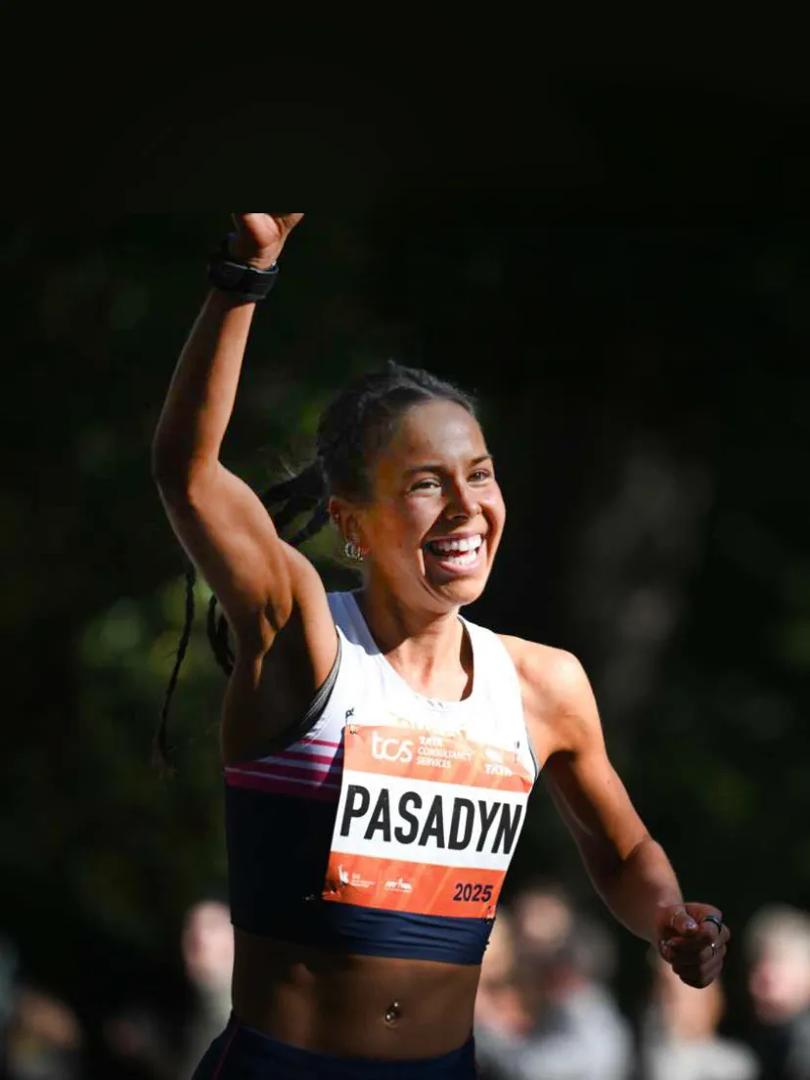 Felicia Pasadyn, a student at NYU Grossman School of Medicine, smiling while she runs in the TCS New York City Marathon.
