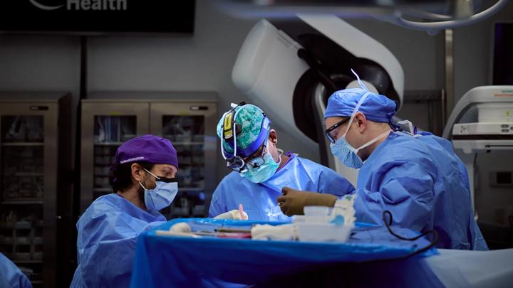 Erez Nossek, MD, performs surgery in an operating room at NYU Langone.