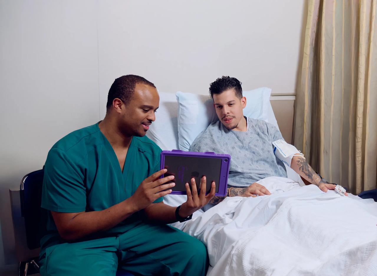 An NYU Langone Health nurse helps a patient understand their treatment plan.