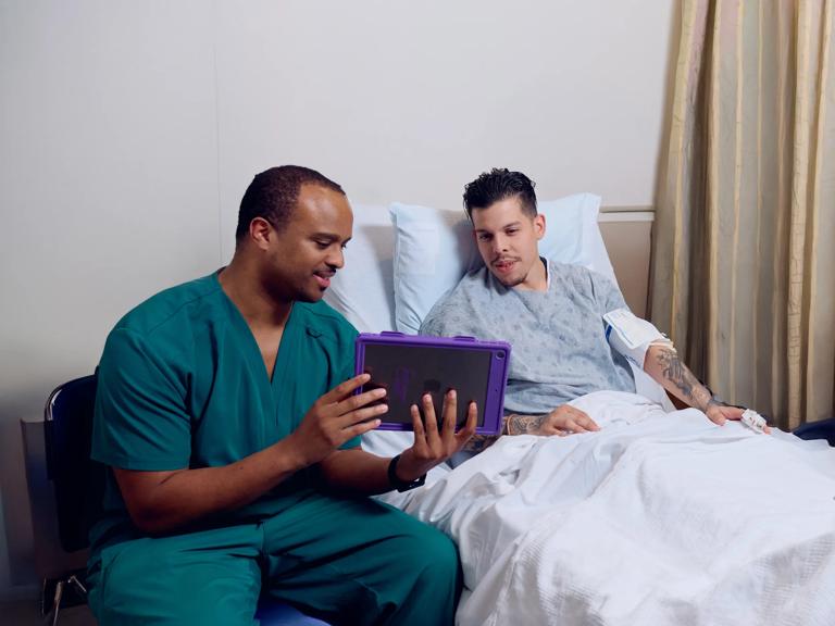 An NYU Langone Health nurse helps a patient understand their treatment plan.