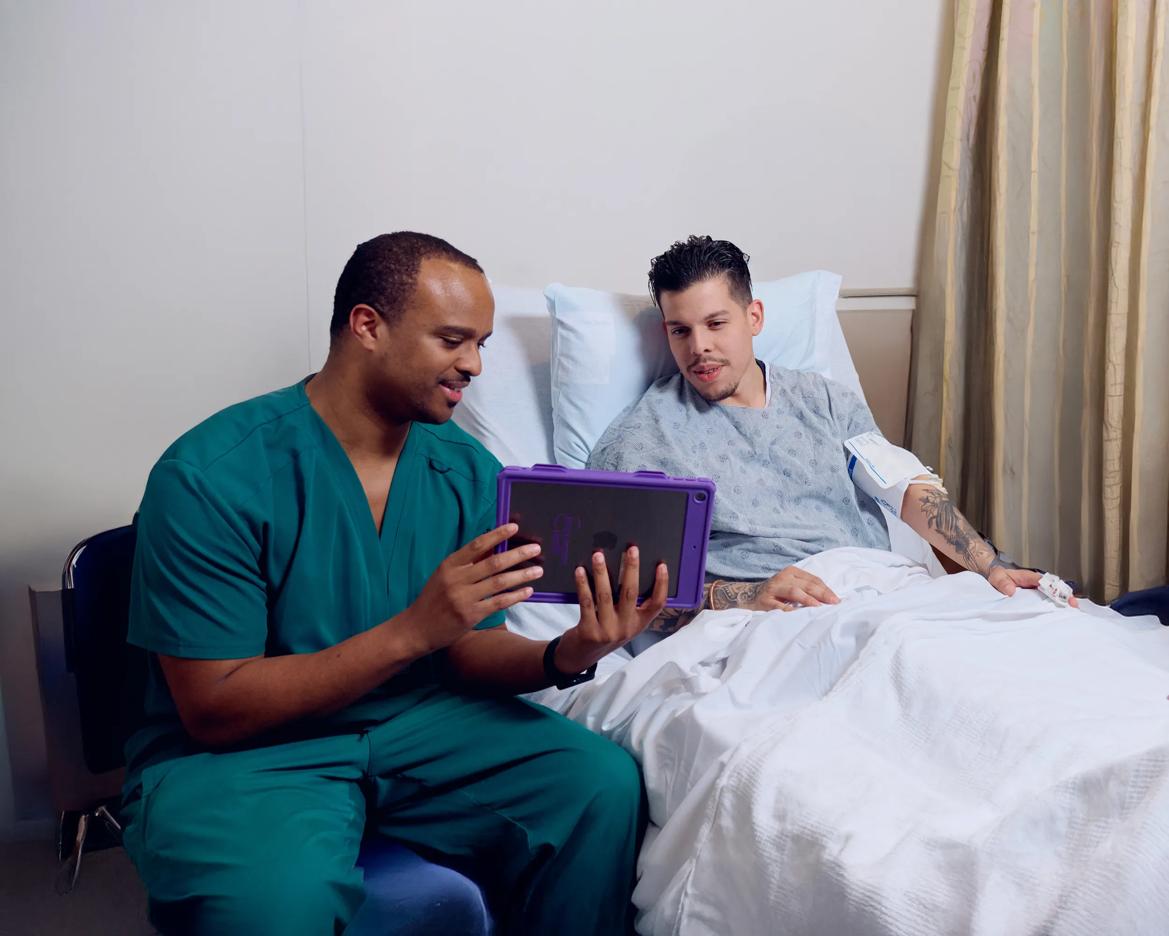 An NYU Langone Health nurse helps a patient understand their treatment plan.