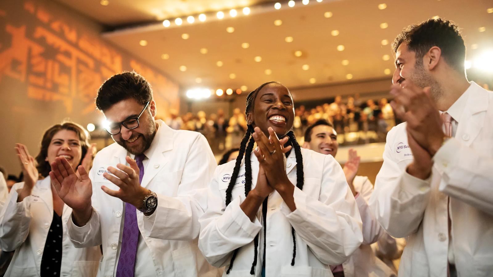 Student recieve their first white jackets during the White Coat Ceremony at NYU Grossman School of Medicine.